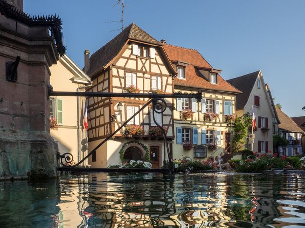 Picture of the main square of Eguisheim across the water