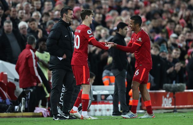 Tyler Morton of Liverpool is substituted on for Thiago Alcantara of Liverpool during the Premier League match between Liverpool and Arsenal at Anfield on November 20, 2021 in Liverpool, England.