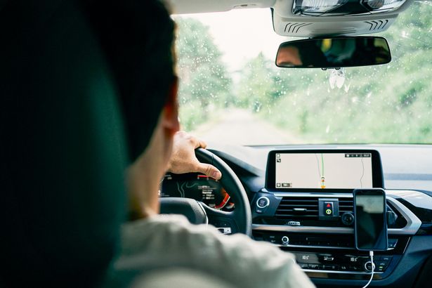 Man inside vehicle driving in a rural area