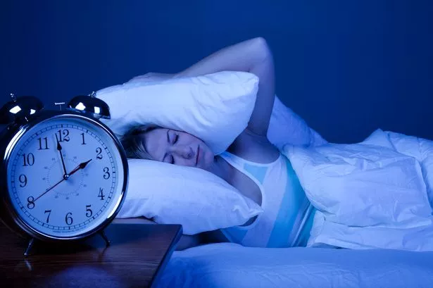 Woman struggling to get to sleep