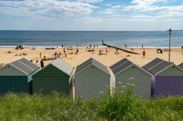 Southbourne, UK - May 21st 2023: Beach huts in front of the sandy Southbourne beach and sea.