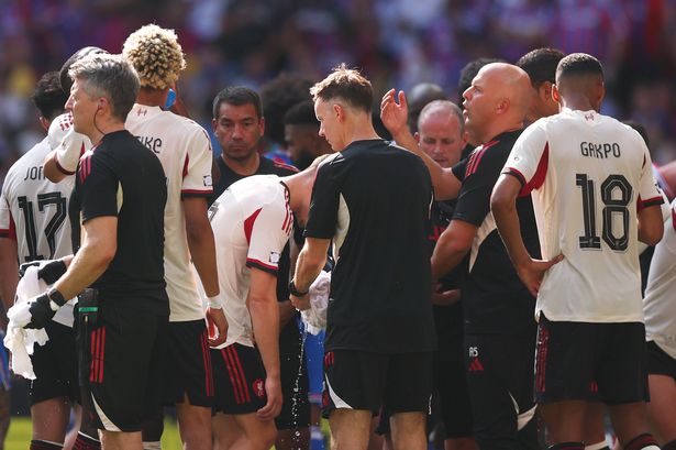 Arne Slot, Manager of Liverpool, gives instructions to his players during a water break in the 2025 FA Community Shield