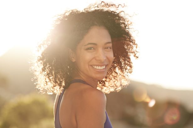Portrait of a young woman in sportswear standing outside