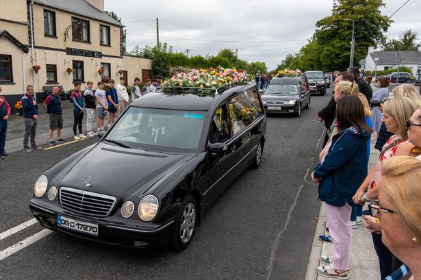 Hearses pass by the guard of honour at the funeral for Vanessa Whyte and her children Sara and James Rutledge