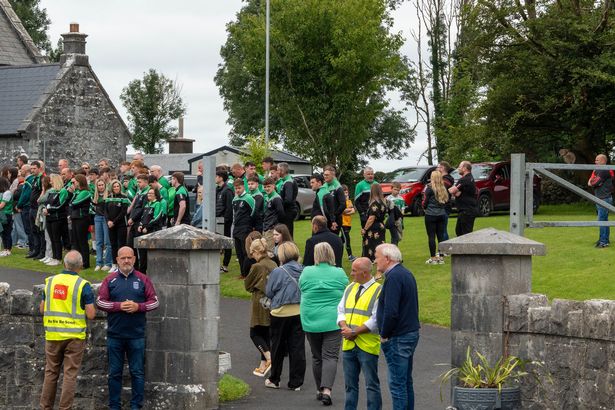 Mourners wearing GAA jerseys