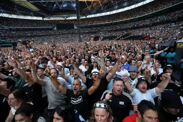 Fans in Wembley Stadium for Oasis' show