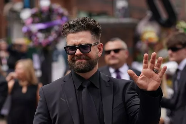 Jack Osbourne waves to the crowd after viewing the messages and floral tributes left at the Black Sabbath Bridge bench on Broad Street in Birmingham in memory of Black Sabbath frontman Ozzy Osbourne