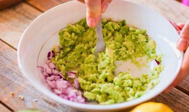 Picture of someone mixing guacamole
