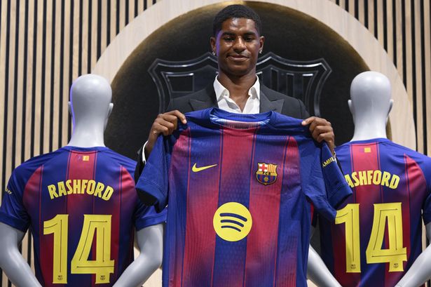 Marcus Rashford holds his Barcelona shirt up
