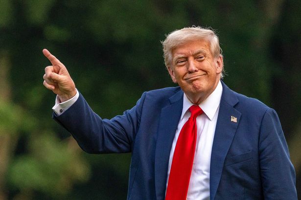 WASHINGTON, DC - JULY 13: U.S. President Donald Trump walks on the south lawn of the White House and points up at the new flag on July 13, 2025 in Washington, DC. President Trump and first lady Melania Trump spend the afternoon attending the final match of the FIFA Club World Cup at MetLife Stadium in East Rutherford, New Jersey. (Photo by Tasos Katopodis/Getty Images)