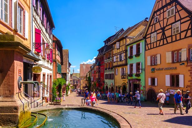 Image of main shopping area in Riquewihr showing colourful buildings