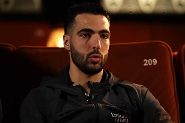 Mikel Merino speaking in an interview while sitting in an old fashioned cinema 