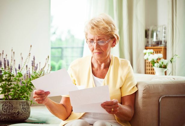 Elderly woman reading papers