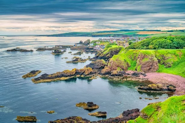 St Abb's Head rocky coastline and St Abb's village in Scotland.