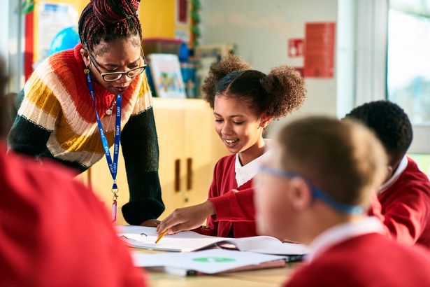 Teacher working with children