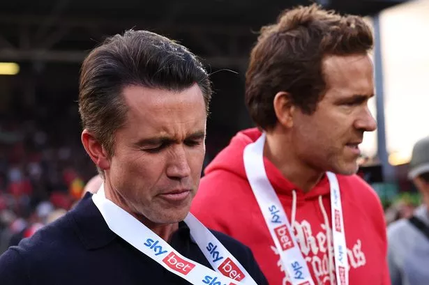 Ryan Reynolds and Rob McElhenney co owners of Wrexham as Rob looks as his runners up medal during the Sky Bet League One match between Wrexham AFC and Charlton Athletic