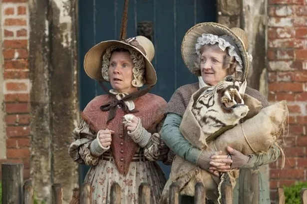 Two women in bonnets look surprised
