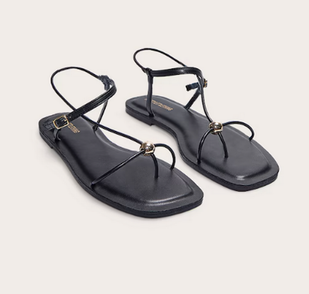 Pretty Little Thing's black and gold sandals