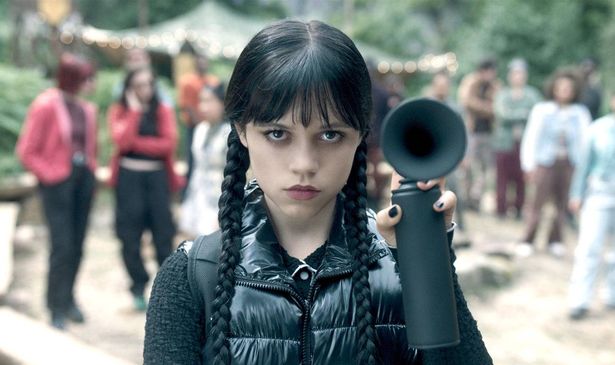 A girl holds a foghorn