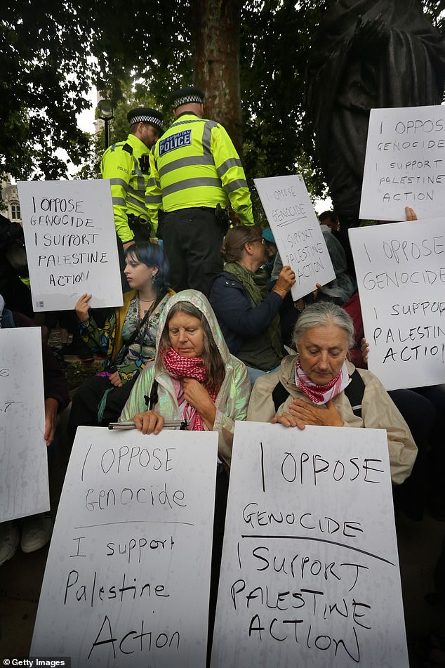Rallies were also held in Edinburgh and Truro to protest the proscription of the campaign group as a terrorist organisation earlier this month. Pictured: Protesters hold up signs in support of Palestine Action at the demonstration in London
