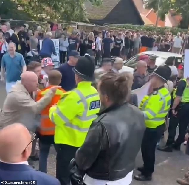 But footage posted on social media, including by supporters of far right activist Tommy Robinson, showed clashes between pro and anti-migrant groups. Pictured: The protest
