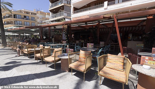 Pictured: Empty chairs outside a restaurant in Majorca a few days ago