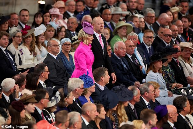 Zara and Mike are pictured arriving at the service in colour-coordinated outfits