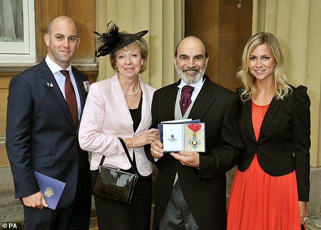 Sir David and Sheila are parents to son Robert (far left) and daughter Katherine, a physiotherapist (far right). The family are pictured together at his investiture