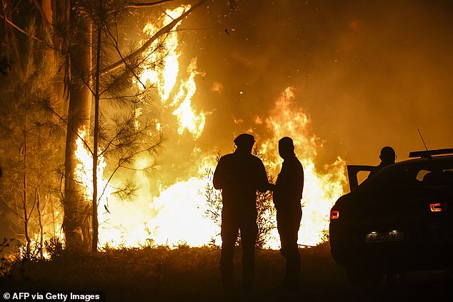 The xtreme weather is wreaking havoc across Europe, pushing emergency services to their limits as wildfires heatwaves and storms sweep across the continent. Pictured: Firefighters work on a wildfire in Arouca, northern Portugal on July 30, 2025