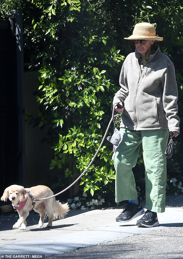 On Sunday, this 82-year-old former actress was spotted enjoying a sunny stroll through her Los Angeles neighborhood, walking leisurely along a hedge-lined sidewalk with her small tan dog sporting a pink harness
