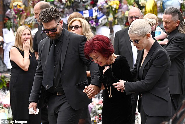 The rock legend was buried in the grounds of his own mansion in Buckinghamshire - as he had said he desired (Ozzy's widow Sharon and his children paying tribute in Birmingham)