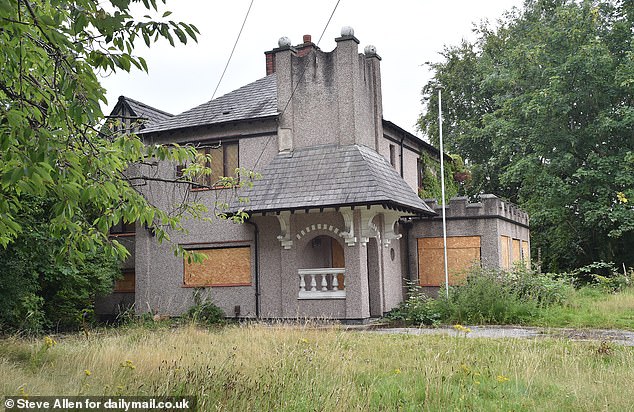 AFTER: The house, which has now been emptied and boarded up along with the cars removed, has recently been sold for a guide price of £325,000