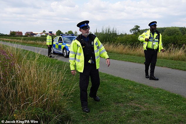 Police are pictured at the scene in Stathern, Leicestershire, after a 76-year-old man was arrested