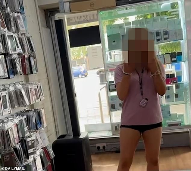 Pictured: A feral teen flipping off the manager of Phone Hub. The pack of girls only target stores run by ethnic minoritie