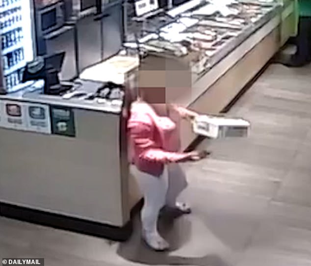 Pictured: One of the thieving teenagers taking an item from Subway. The pack of girls spend every afternoon drunk attempting to steal the cookie cabinet from Subway