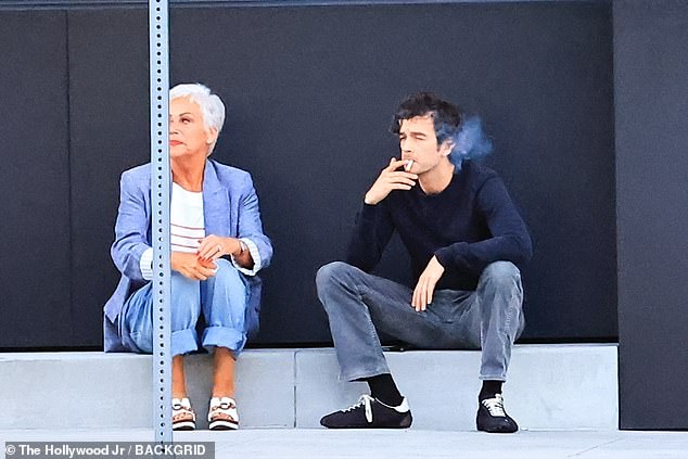 The former Coronation Street star looked glum as she stared into the distance, while Matty took the opportunity to puff on a cigarette while supporting is mother