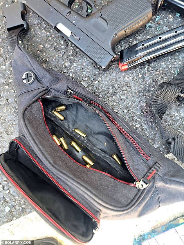 A close up of one of the pistols and a small bag full of ammunition - both allegedly found inside the vehicle