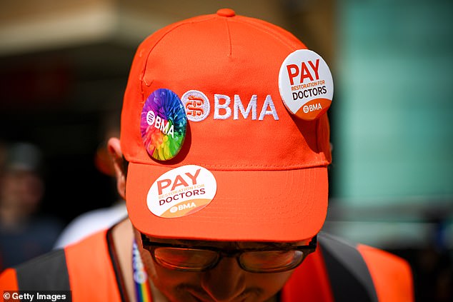 A BMA spokesperson said that the NHS England claims that the majority of resident doctors chose not to strike 'requires a huge stretch of the imagination'. Pictured: A striking doctor protests outside Bristol Royal Infirmary hospital