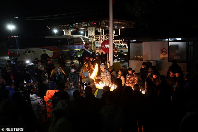 People hold a vigil at an entrance to El Teniente mine complex of the Chilean state-run copper producer Codelco, as rescue teams continue efforts to reach miners trapped after a tremor at the Andesita unit, in Maitenes, Chile, August 2, 2025