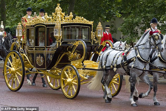 The late Queen Elizabeth II and Prince Philip are pictured riding in the Diamond Jubilee state coach from Buckingham Palace to Parliament to attend the State Opening of Parliament in 2014. Tyrone is pictured pulling the carriage