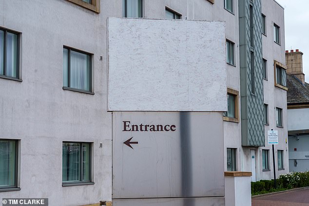 A four-star migrant hotel, pictured, has covered up its Hilton branding after protesters targeted similar buildings