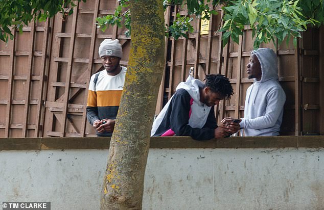 Residents pictured at the rear of the hotel. The DoubleTree by Hilton in Cranford, west London, closed itself off to its traditional clientele of tourists and business travellers in November after admitting a host of all-male migrants