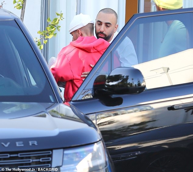 The performer greeted a friend with a hug as they arrived to the establishment