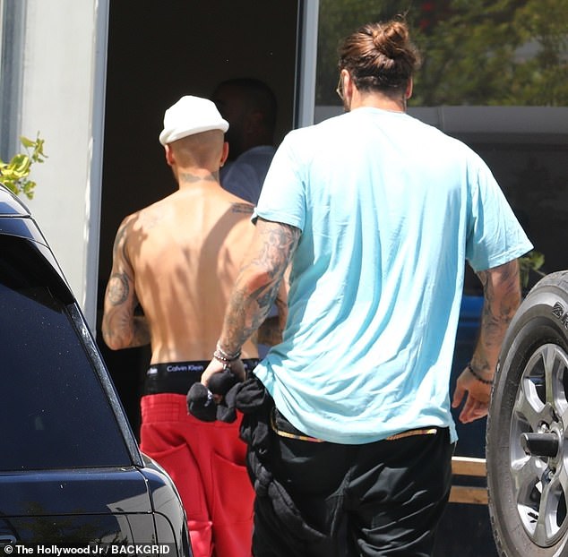 Justin later removed the outer piece and opted to go shirtless as he entered the building - only weeks after he officially launched the website for his SKYLRK clothing brand on July 10