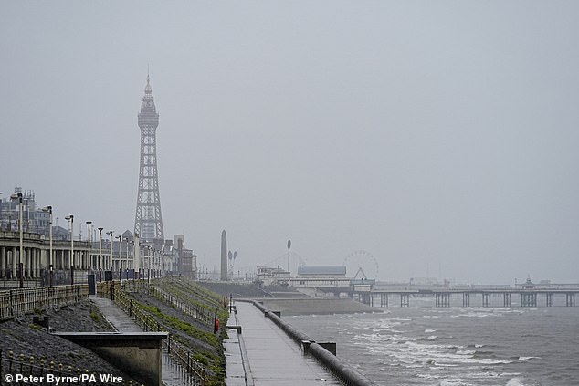 Grey skies and choppy waters at the promenade in Blackpool as the tower stands in the background