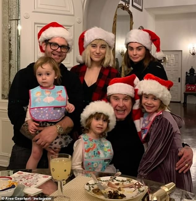 Aree Osbourne - who married Ozzy's son Jack in 2023 - shared a slew of adorable family snaps that showed the rocker enjoying quality time with his grandchildren (Ozzy, pictured with Jack, Aree and Aimee - back row - and Jack's children)