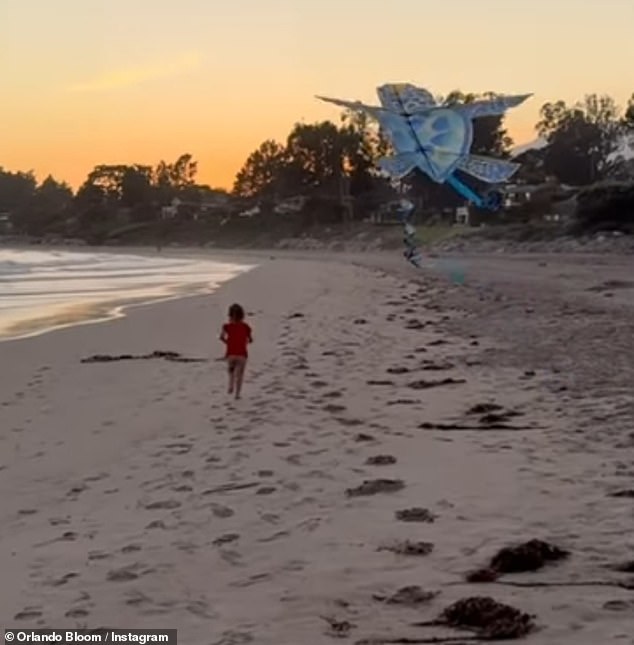 The Lord of the Rings star looked ever the doting dad as he proudly filmed Daisy running along the beach flying a kite