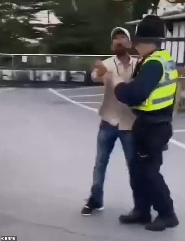 The migrant flicked a cigarette towards the group before shouting back at them