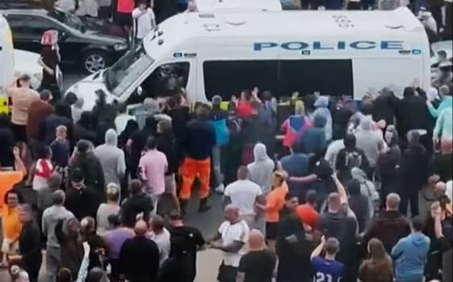 Hart, pictured close to the bonnet of this van, attacked the vehicle