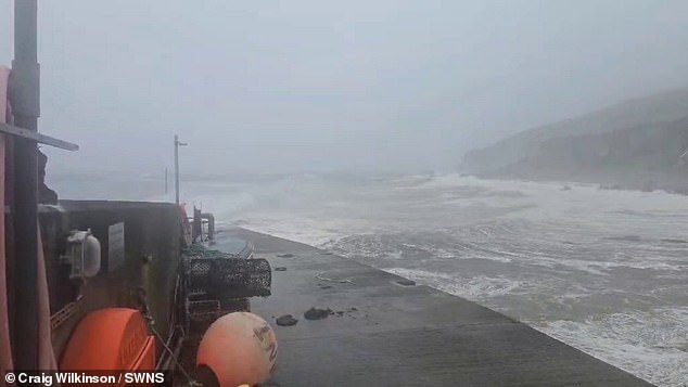 Waves and wind batter a ship off the Isle of Skye in Scotland as Storm Floris causes disruption